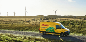 DHL delivery van in front of pinwheels