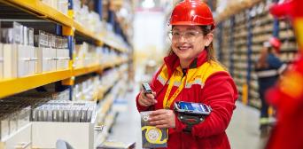 DHL employee with digital device