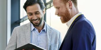 Two men with laptop