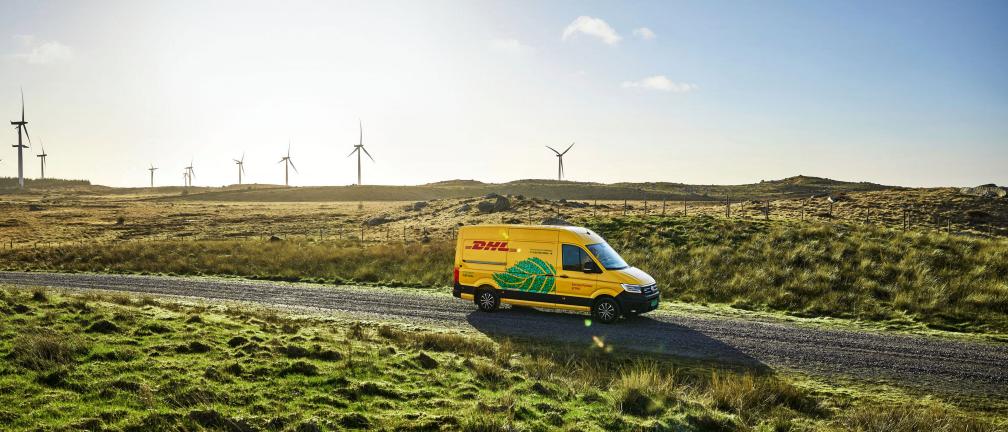 DHL vehicle in front of wind turbines