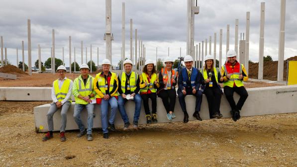 Local representatives sitting on a contruction beam