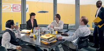 A group of office workers sitting around a table.