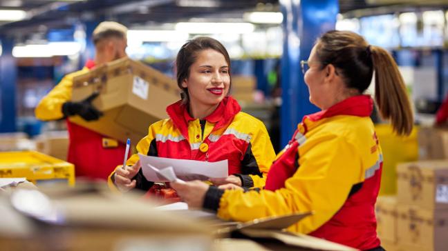 DHL employees in a warehouse.