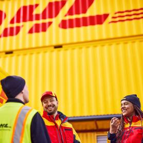 Two men and one woman in DHL clothing in front of a DHL container.