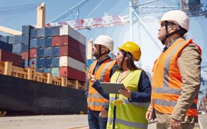 Employees in front of a container vessel